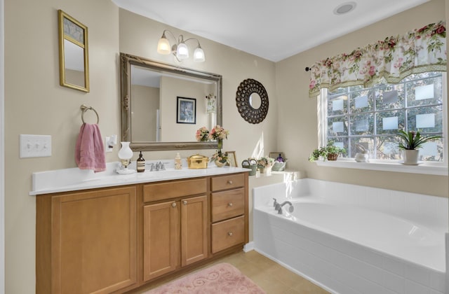 bathroom with tiled tub and vanity