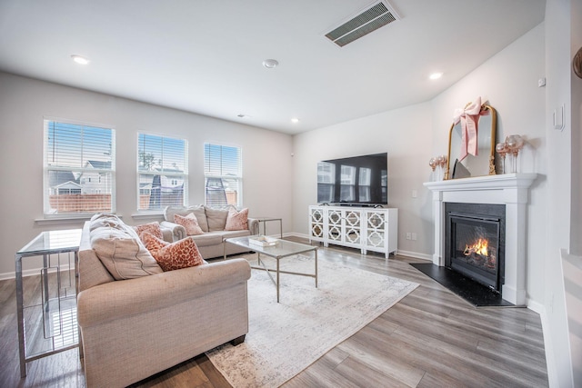 533 Richfield Way, Summerville, SC 29486 - living room with visible vents, a glass covered fireplace, wood finished floors, baseboards, and recessed lighting