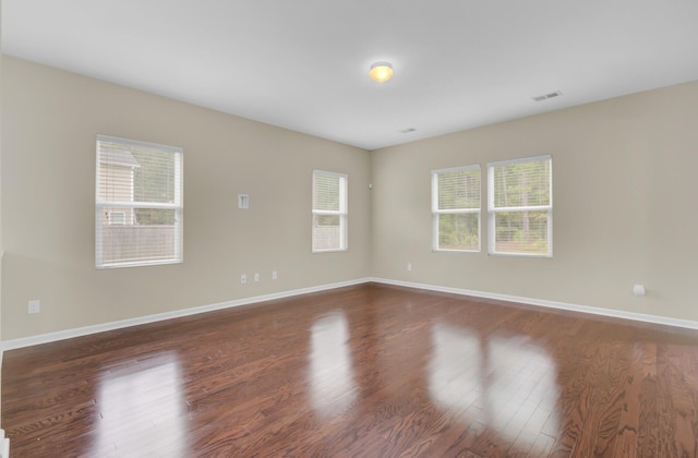 unfurnished room featuring dark hardwood / wood-style flooring