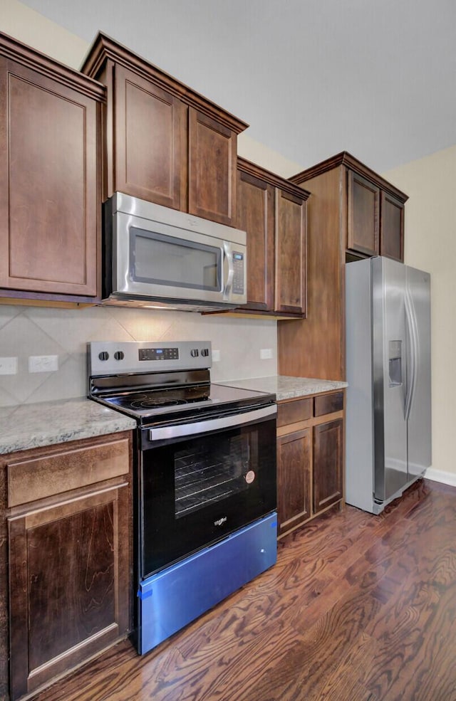 kitchen with dark brown cabinets, backsplash, stainless steel appliances, and dark wood-type flooring