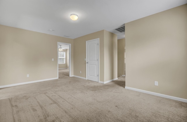 unfurnished room featuring ceiling fan and light colored carpet