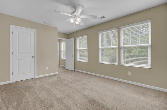 unfurnished bedroom with light carpet and ceiling fan