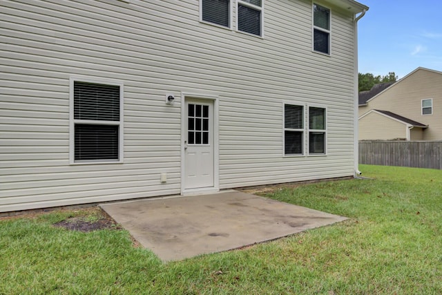 rear view of house featuring a patio area and a lawn