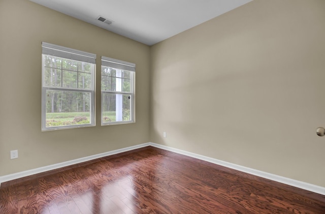 empty room featuring dark wood-type flooring