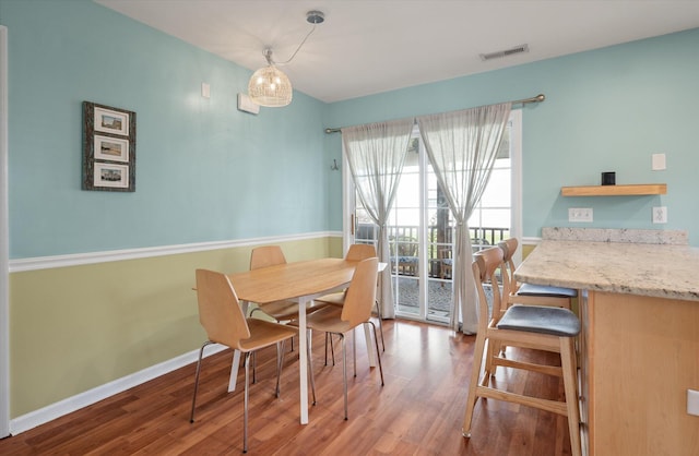 dining space with hardwood / wood-style flooring