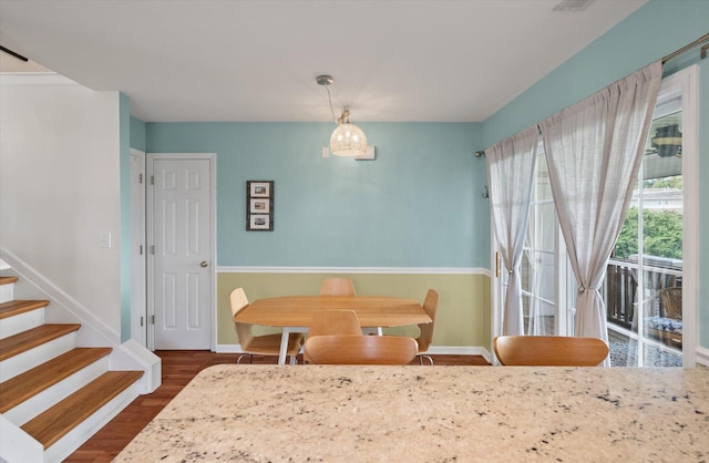 dining space with dark hardwood / wood-style flooring