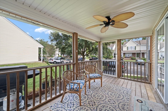 sunroom / solarium featuring ceiling fan