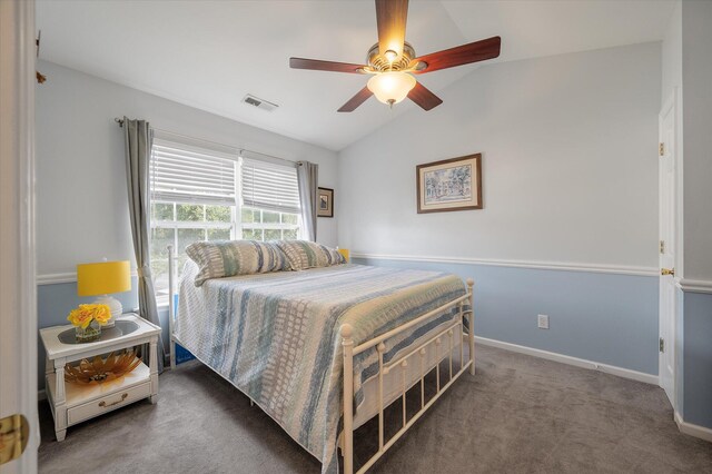 carpeted bedroom with ceiling fan and vaulted ceiling