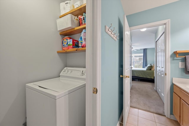 laundry area featuring washer / dryer and light carpet