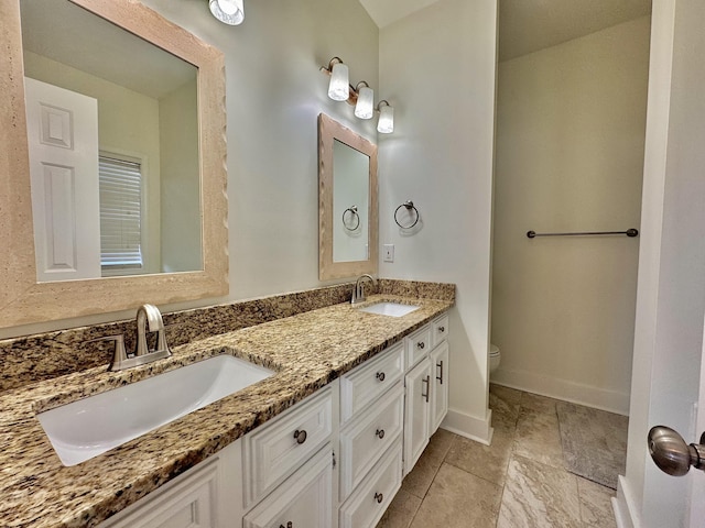 bathroom with toilet and vanity