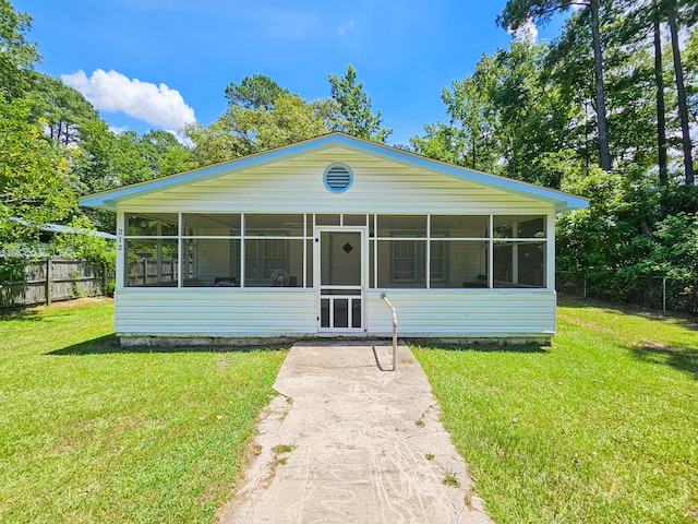 manufactured / mobile home featuring a sunroom and a front lawn