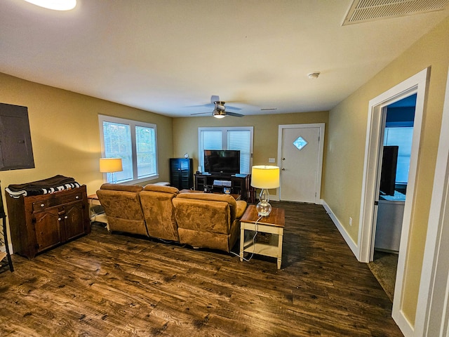 living room featuring dark wood-type flooring and ceiling fan