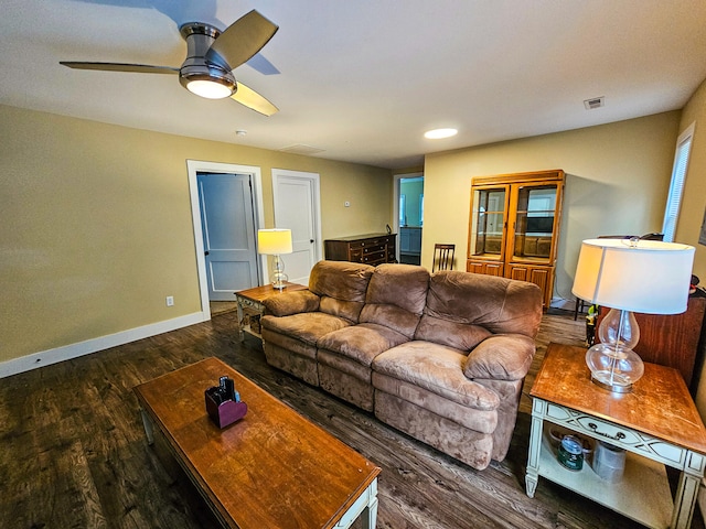 living room featuring dark hardwood / wood-style flooring and ceiling fan