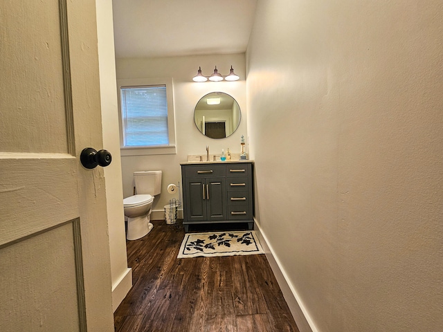 bathroom with vanity, toilet, and wood-type flooring