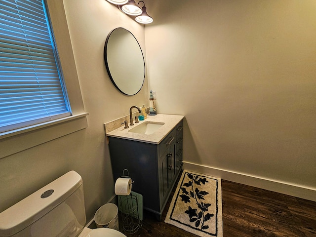 bathroom with vanity, toilet, and wood-type flooring