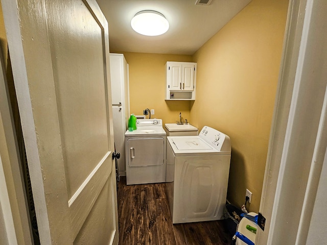 laundry room featuring sink, cabinets, independent washer and dryer, and dark wood-type flooring