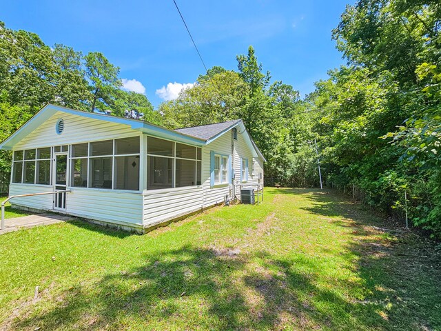 exterior space with a sunroom and central AC unit