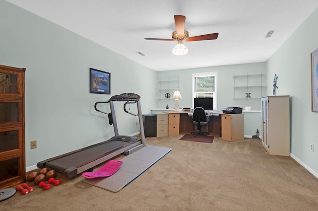 office area featuring light colored carpet, ceiling fan, visible vents, and baseboards