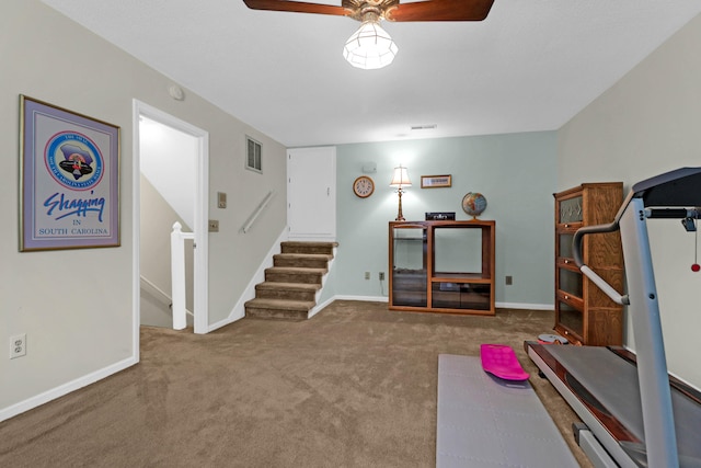 exercise room featuring carpet floors, visible vents, and baseboards