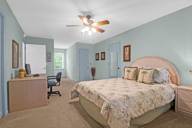 bedroom with a ceiling fan and light colored carpet