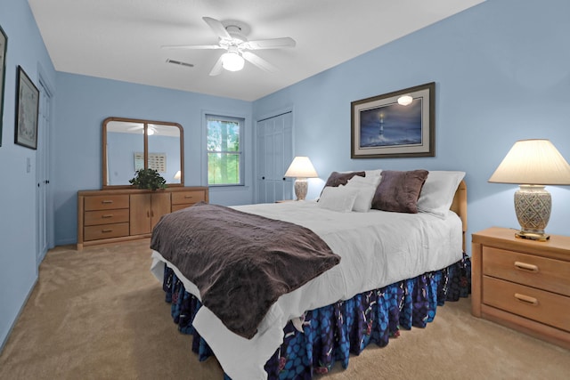 bedroom with visible vents, a ceiling fan, and light colored carpet