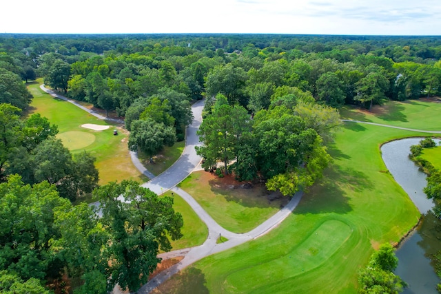 birds eye view of property featuring a forest view, golf course view, and a water view