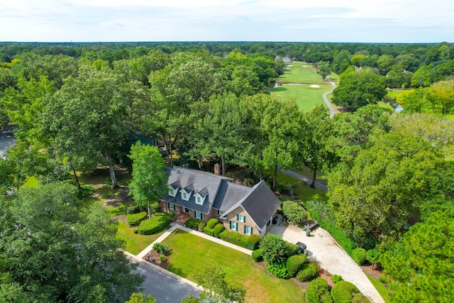 birds eye view of property with a view of trees