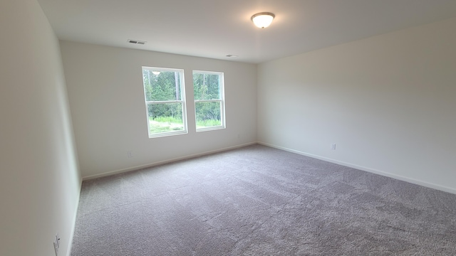 empty room with carpet and baseboards