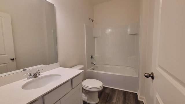 full bath with toilet, wood finished floors, vanity, and  shower combination