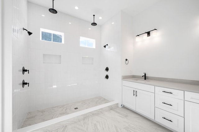 bathroom with vanity and tiled shower