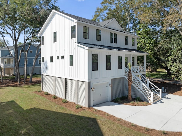 view of front of house with a garage, covered porch, and a front lawn