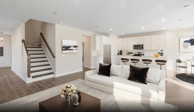 living room featuring light hardwood / wood-style flooring and a chandelier