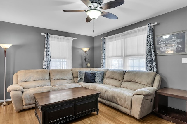 living room with light wood-style flooring and ceiling fan