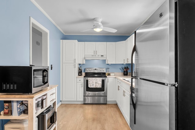 kitchen with ornamental molding, stainless steel appliances, light countertops, under cabinet range hood, and white cabinetry