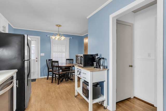 kitchen featuring white cabinetry, appliances with stainless steel finishes, light countertops, and light wood finished floors