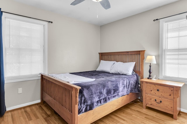 bedroom featuring wood finished floors, baseboards, and ceiling fan