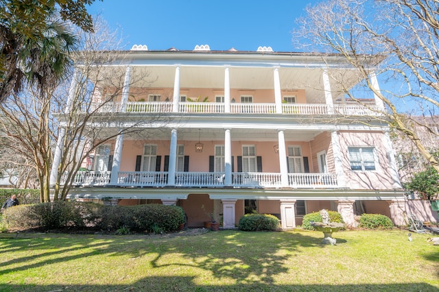 view of front of property with a front lawn and a balcony