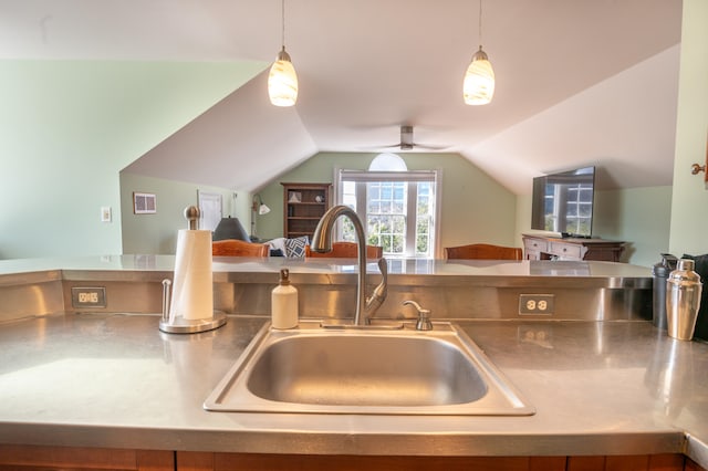 kitchen featuring ceiling fan, pendant lighting, vaulted ceiling, and sink