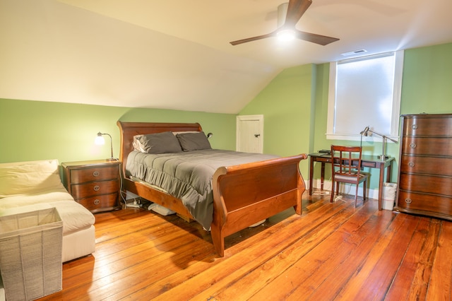 bedroom featuring light wood-type flooring, ceiling fan, and vaulted ceiling