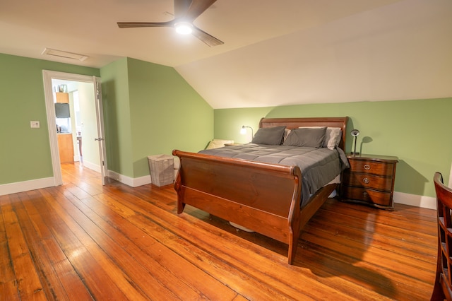 bedroom featuring ceiling fan, hardwood / wood-style flooring, and lofted ceiling