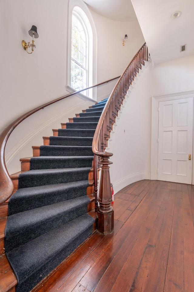 staircase featuring wood-type flooring