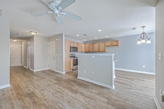 kitchen with light brown cabinetry, ceiling fan with notable chandelier, light wood-style floors, appliances with stainless steel finishes, and baseboards