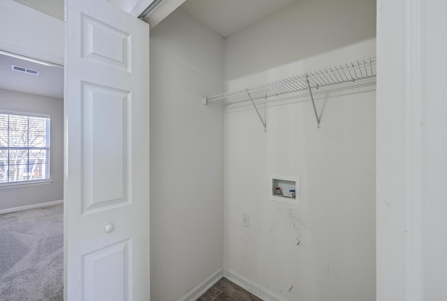 clothes washing area featuring visible vents, baseboards, hookup for a washing machine, and laundry area