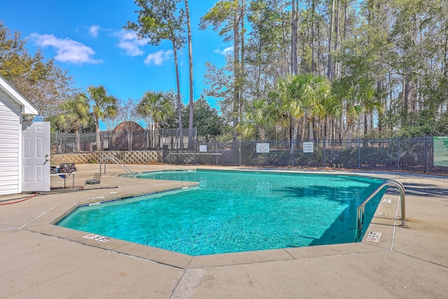 community pool featuring a patio area and fence