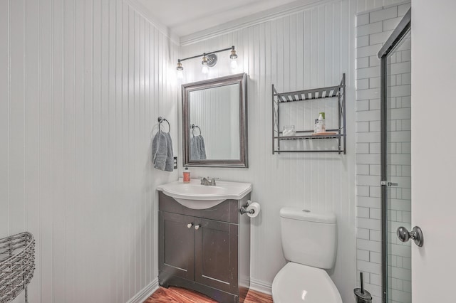 bathroom featuring toilet, baseboards, and vanity