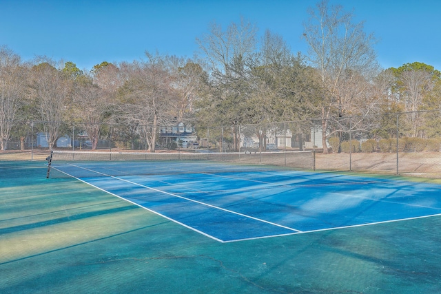 view of tennis court with fence