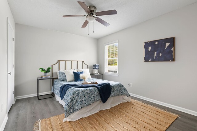 bedroom with wood finished floors, baseboards, and a ceiling fan