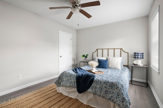 bedroom with wood finished floors, baseboards, and ceiling fan
