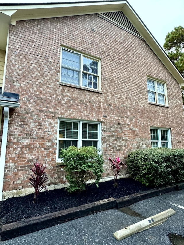 view of property exterior featuring brick siding
