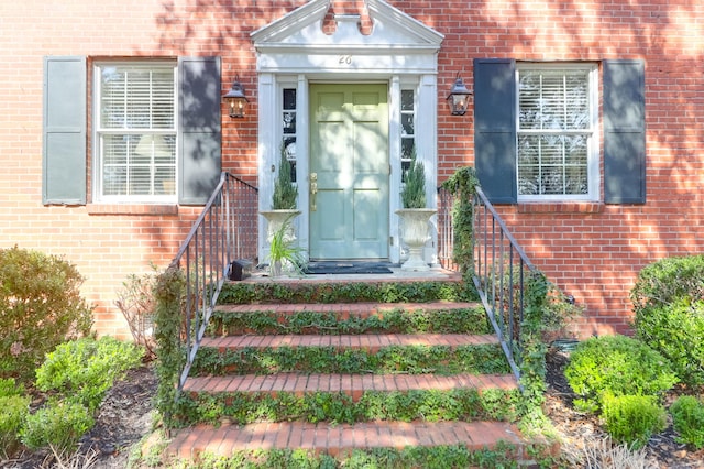 view of exterior entry with brick siding